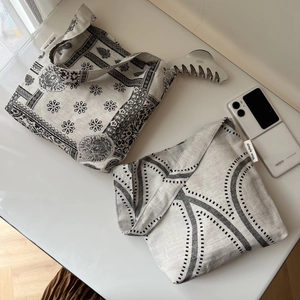Detail of vintage cotton-linen shoulder bag featuring black paisley and wave patterns