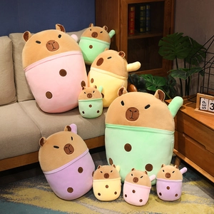 Cute capybara plushies in milk tea cups of various colors and sizes on a cozy sofa