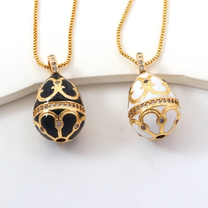 Macro detail of Fabergé style enamel egg pendants with golden filigree and crystals