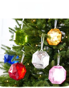Detail of colorful faceted gemstone ornaments hanging on a Christmas tree branch