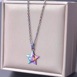 Macro shot of 18k vacuum plated rainbow star pendant with face relief on O-chain