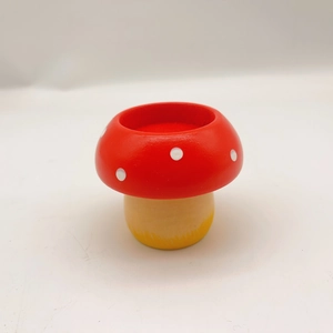 Mushroom wooden candle holder with red white spotted top for festive table decoration