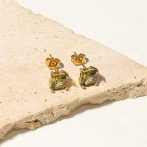 Detail of square green zircon stud earrings with 18K gold-plated stainless steel setting