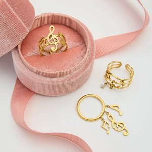 Macro shot of gold stainless steel rings featuring musical note and treble clef designs