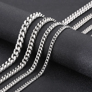 Macro shot of silver titanium steel Cuban chains in various thicknesses on black display