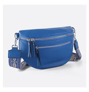 Close-up of royal blue litchi leather waist bag with silver zippers and ethnic strap