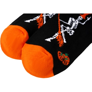 Close-up of Halloween socks showing detailed knit texture with skeleton and broom pattern