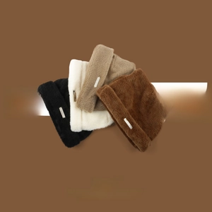 Detail of soft faux fur knit beanies with cat ears and small metal logo plates