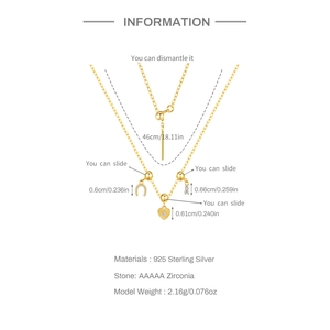 Detailed view of S925 silver charm necklace with specs on gold heart and bar pendants