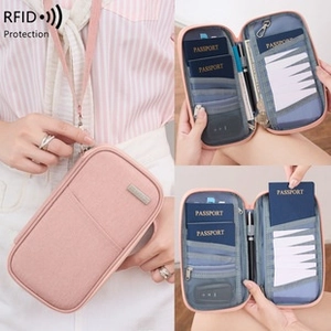 Pink RFID blocking passport holder showing internal slots and neck strap usage