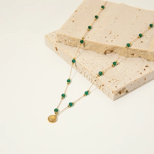 Elegant gold titanium steel necklace with turquoise beads and a golden shell pendant