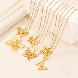 Elegant gold butterfly pendant necklaces displayed on white stones in various styles