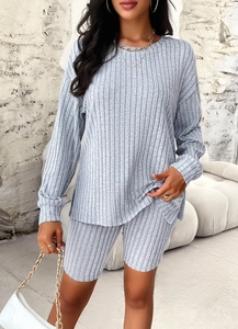 Detailed view of women's grey ribbed knit lounge set featuring long sleeves and shorts