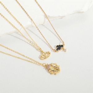 French vintage gold necklaces with beetle, lotus and cloud pendants featuring pink zircons