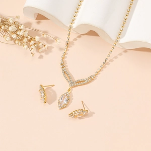 Detailed macro view of gold-plated tassel necklace and zircon earrings bridal jewelry set