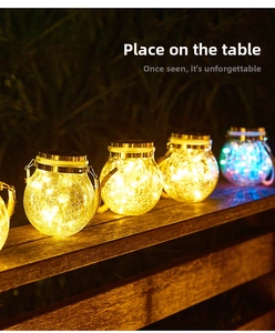 Close-up of solar crackle glass jars with warm and blue LED lights on wooden table