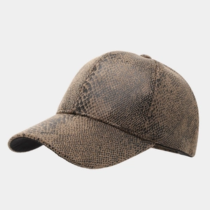 Detailed macro view of the brown snakeskin pattern texture on the baseball cap material