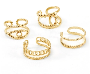 Detailed view of four 18K gold plated stainless steel rings with bead and chain textures