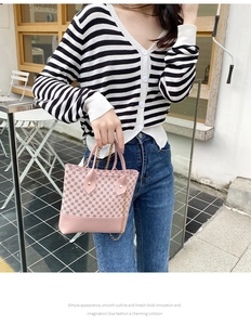 Close-up of pink geometric pattern handbag with gold studs and elegant metal chain