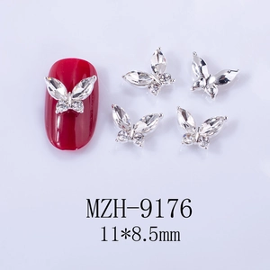 Macro shot of 11x8.5mm 3D butterfly nail charms with rhinestones on red manicure tip