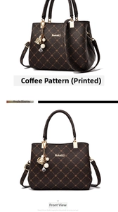 Detail view of coffee print handbag featuring gold hardware and pearl flower charm