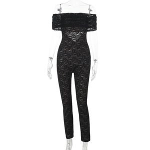 Close-up of black lace off-shoulder jumpsuit with intricate sheer floral pattern details