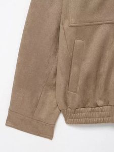 Detail of brown faux suede jacket featuring cuff stitching and elastic waistband