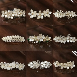 Detailed set of golden hair clips with rhinestones, pearls and opal floral motifs
