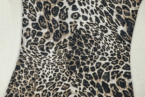 Close-up of lightweight leopard print fabric showing detailed texture and sheer brown pattern