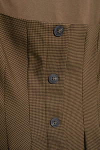 Detail of vintage brown houndstooth fabric with buttons on a slim mini dress