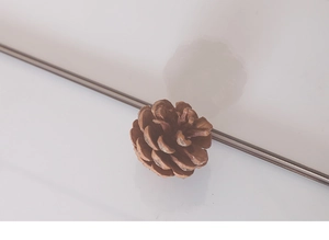 Detail of pinecone-shaped resin decorative ornament with lifelike scale texture