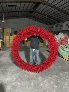 Extra large red berry Christmas wreath held in hand showing realistic texture and size