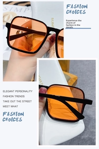 Detailed close-up of square half-frame sunglasses with amber lenses and textured case