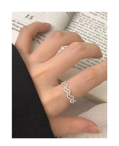 Close-up of minimalist S925 sterling silver twisted rope wave ring worn on finger