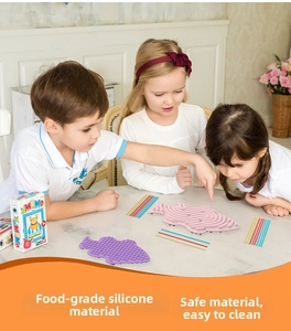 Three children playing with fish-shaped silicone sensory boards in a bright home setting