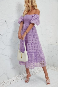 Detail of light purple tiered dress with smocked bodice and square pattern texture