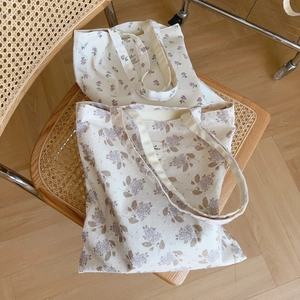 Floral print cotton canvas tote bag with dual shoulder straps and minimalist fabric label