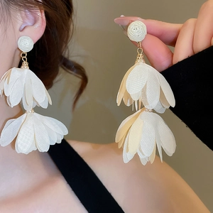 Close-up of elegant cream white chiffon petal tassel earrings with gold hardware