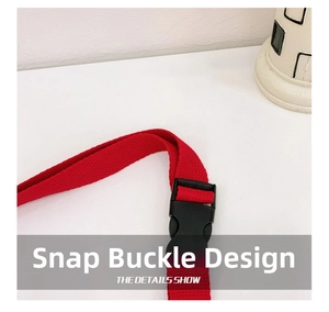Detail of red nylon shoulder strap with a black plastic buckle for kids cartoon bags