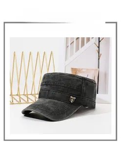 Detail of vintage black cadet cap with side metal badge and washed denim texture