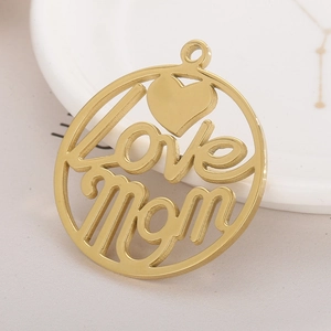 Golden stainless steel Love Mom pendant with hollow heart on a white ceramic plate