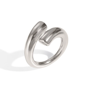 Detailed view of a twisted silver-toned metal open ring with a polished glossy finish