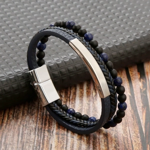 Close-up of blue braided leather bracelet with matte black and navy textured beads