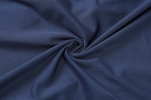 Detailed macro view of dark blue knitted fabric texture showing softness and elasticity