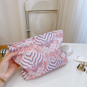 Detail of Chinese cloud pattern on red and blue fabric makeup bag with zipper