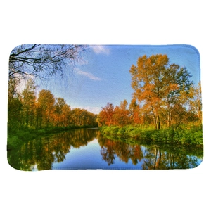 Absorbent flannel floor mat featuring a golden autumn river landscape with blue sky