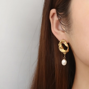 French vintage 18K gold irregular lava earrings with white pearl drop on model
