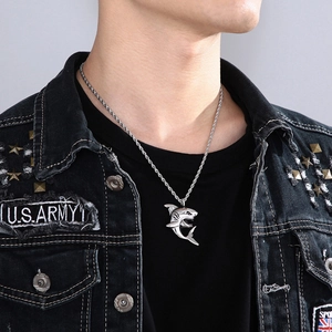 Silver shark pendant necklace with twist chain shown on model in a close-up neck view