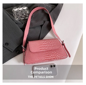 Detailed view of pink crocodile embossed shoulder bag with silver buckle and adjustable strap