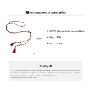 Detail view of 128cm wood bead cord with red tassels and golden alloy accents